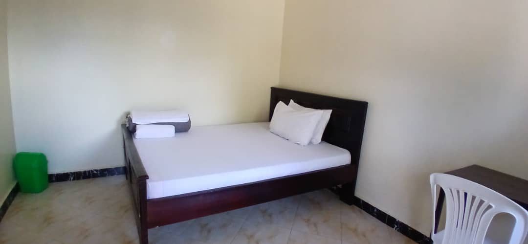 Bright room with a double bed and white linen